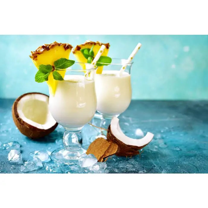 Piña Colada i glas med ananas och kokosnöt bredvid